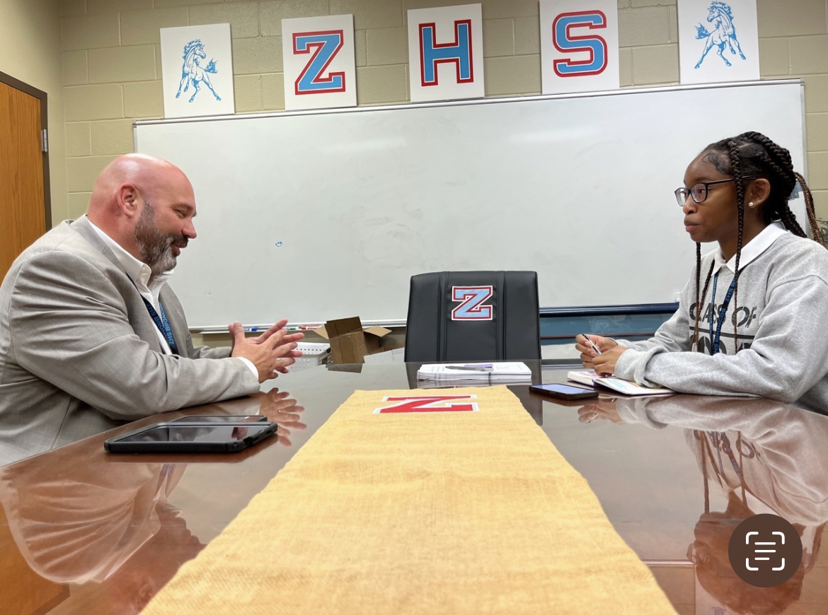 Alyvia Pierson (12) interviews superintendent, Mr. Ben Necaise, about issuing new regulations and the Zachary community. 