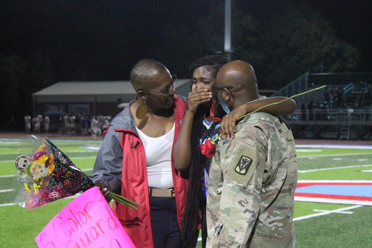 Anna Jordan (12) is recognized as a member of the Fillies color guard team as she was surprised by her father who returned from Camp Humphries, South Korea, on duty.