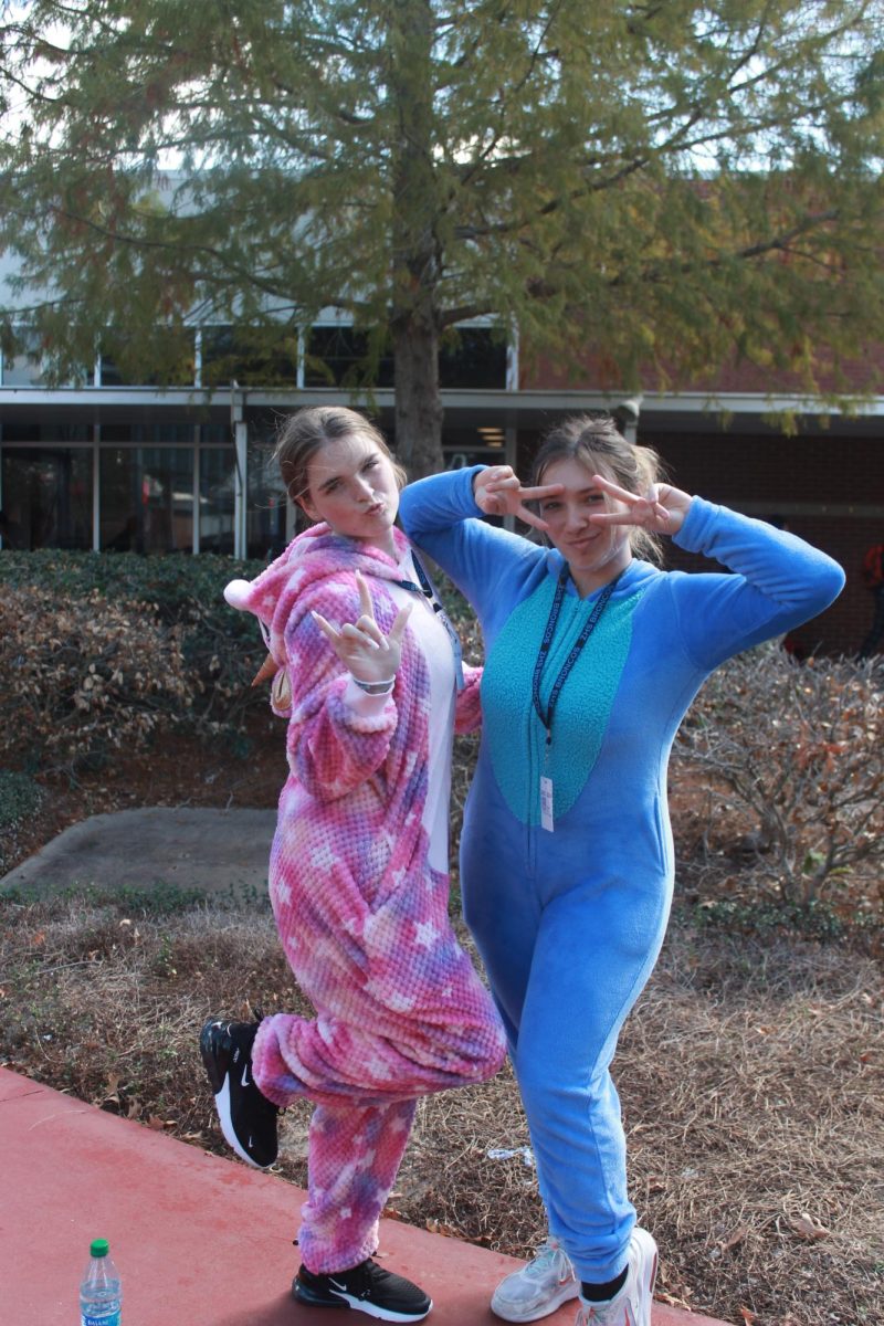 Addison Paxton (11) and Remi Quibodeaux (12) wear matching onesies as Eeyore from Winnie the Pooh. 