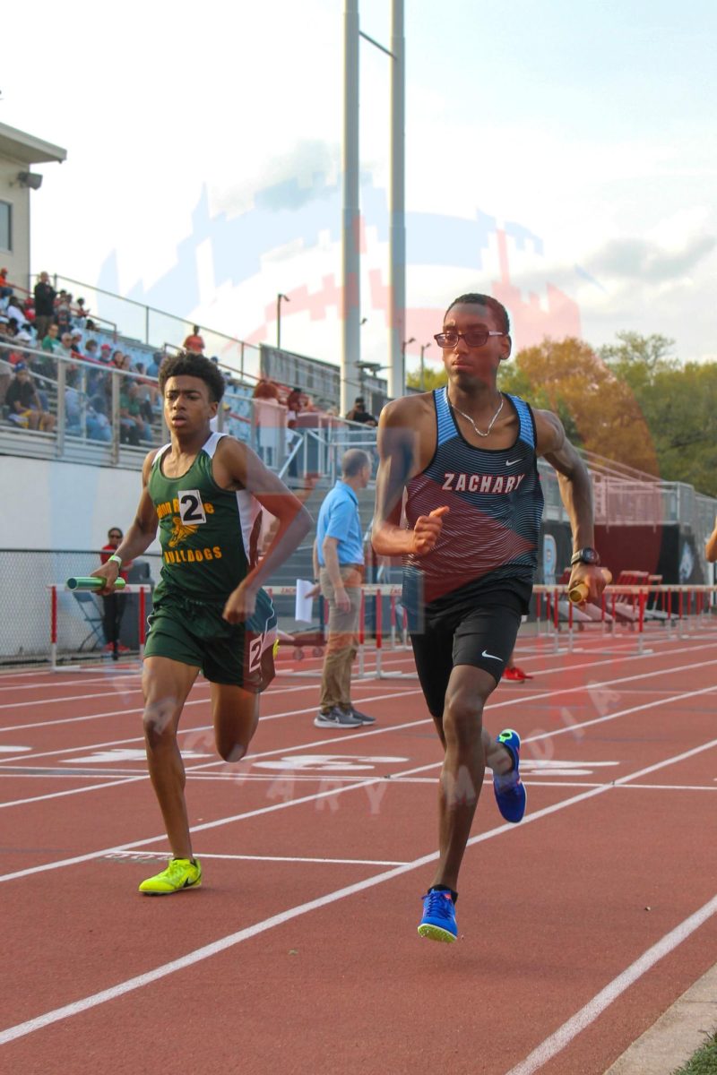 Tekoah Simpson (10) competes alongside a Baton Rouge High runner, in the sprint race.