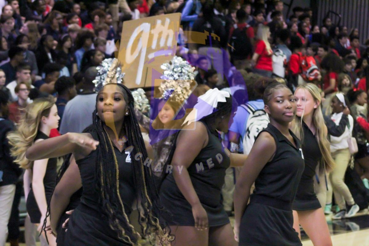 The JV Cheerleading squad performs a routine before the pep rally begins. The JV team was one of many teams that helped get the crowd fired up. 