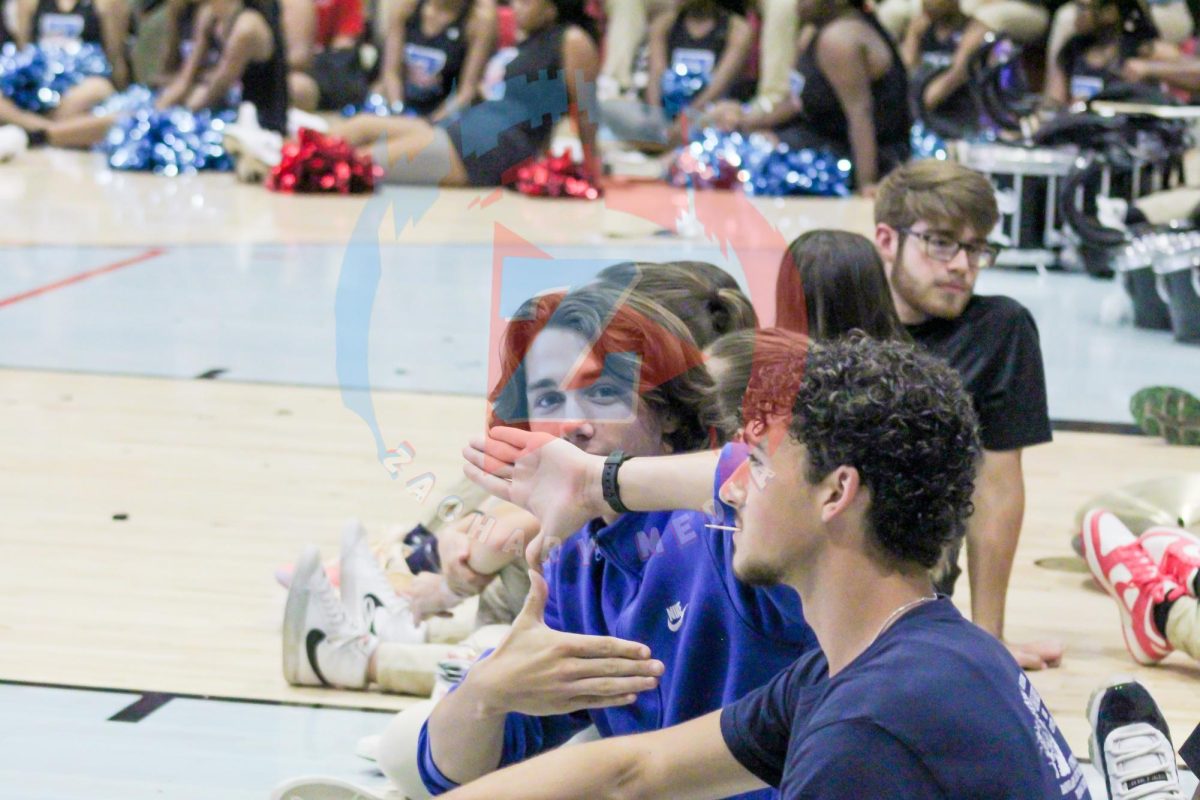 Dillon Samson (12) flashes up a "Z" to show his Zachary spirit. As part of the band, Samson enjoyed the energetic, boisterous environment of the pep rally.