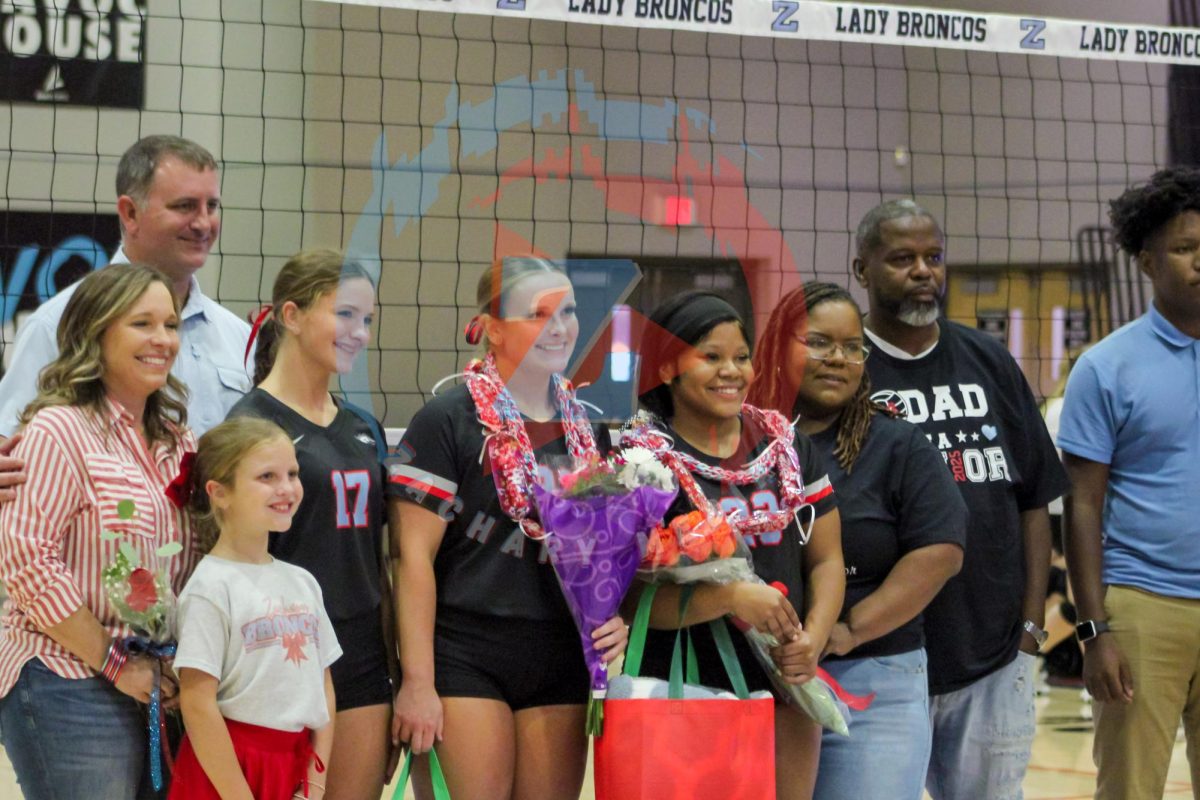 Both the Mitchem and Franklin families take a picture to commemorate the special night for their daughters. Both families happily cheered on the Lady Broncos.