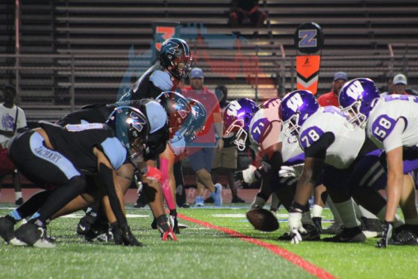 The Bronco defensive line braces for another Woodlawn snap. The defensive line, along with other linebackers for the Broncos, recorded many sacks throughout the game.