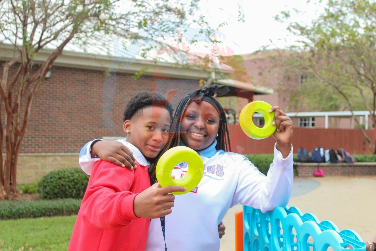 Jiyah Tucker (9) and Ahmad Jarreau (9) pose with the Connect Four pieces after their game. The students loved taking a break from the school day to relax and have some fun!