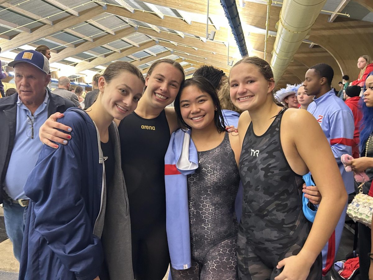 From left to right, Maddy Snyder (12), Evelyn Deroche (12), Ava Ordonio (11), and Chloe Wedblad (11) smile together after breaking the school record for the 400-freestyle relay. The girls also hold the school record for the fastest 200 medley relay.