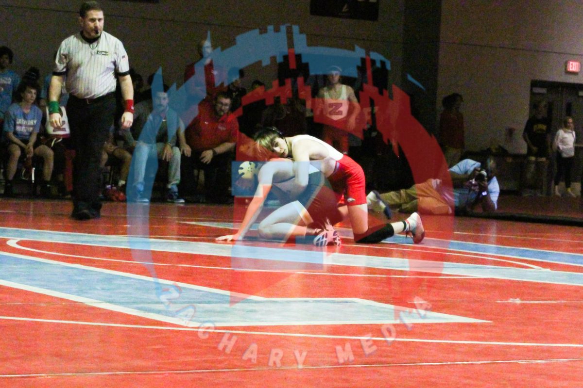 Gavyn Meadows (12) pinning the opponent to the ground for a win.