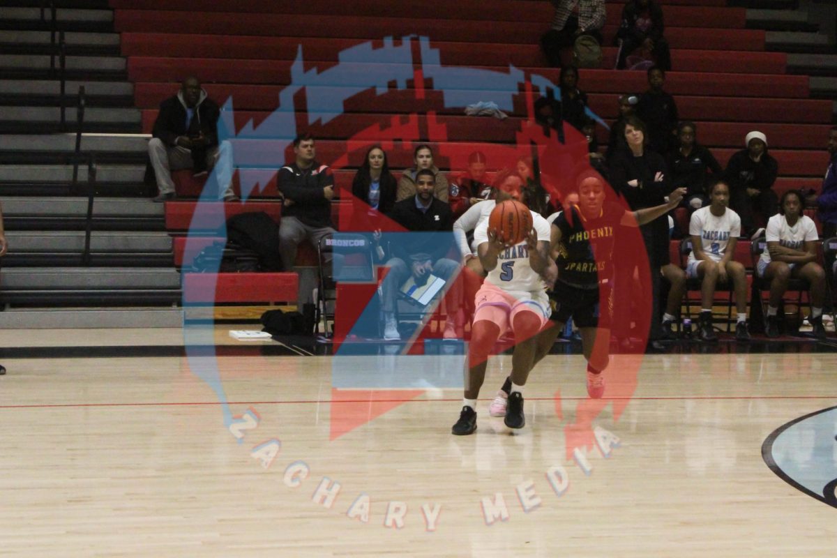 Kaitlyn Blake (12) blocks the opponent from getting the ball.