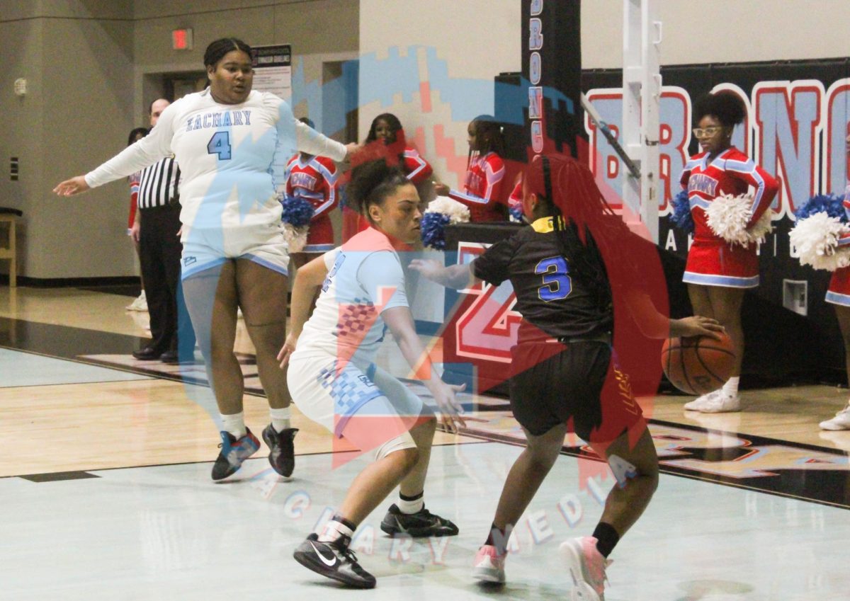 Ayja Walker (10) blocking the ball from going in the basket.