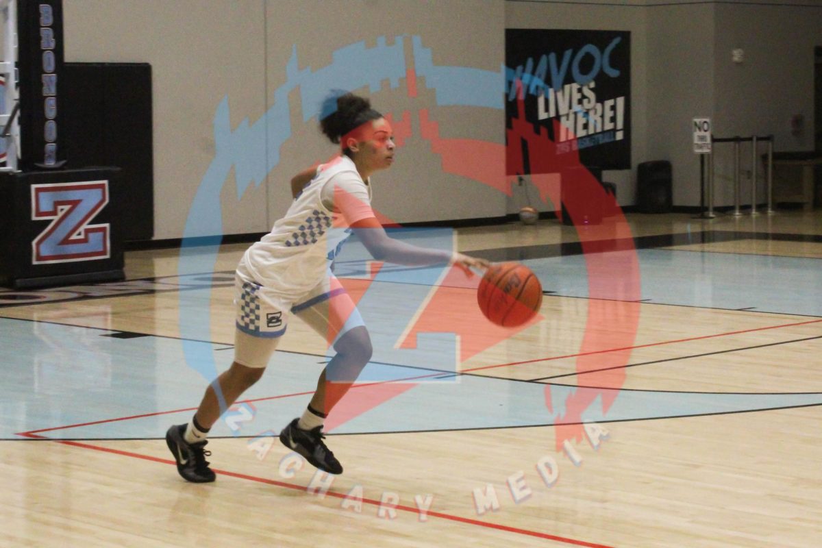 Ayja Walker (10) dribbles the ball down the court.