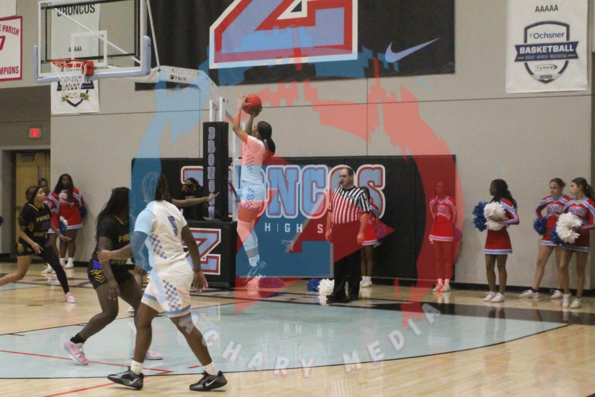 Ava Raymond (11) shoots the ball from the side of the basket. 