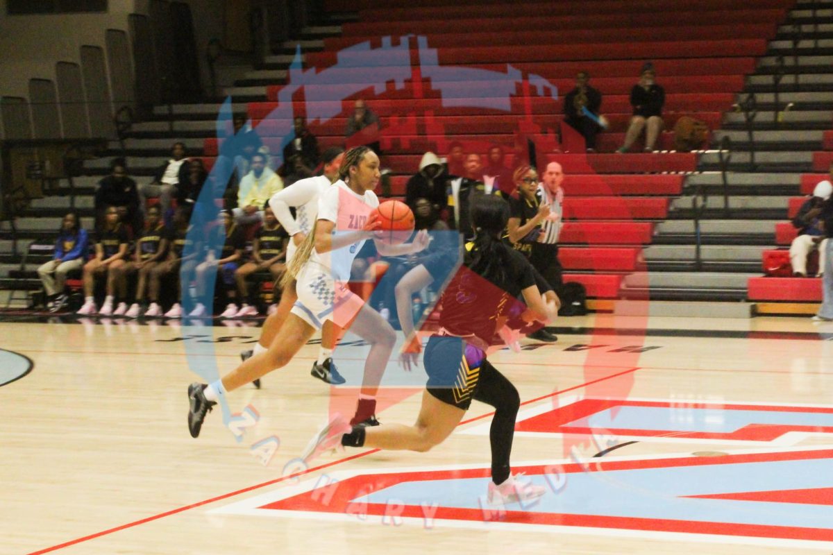 Asia Bell (9) running down the court dribbling the ball. 