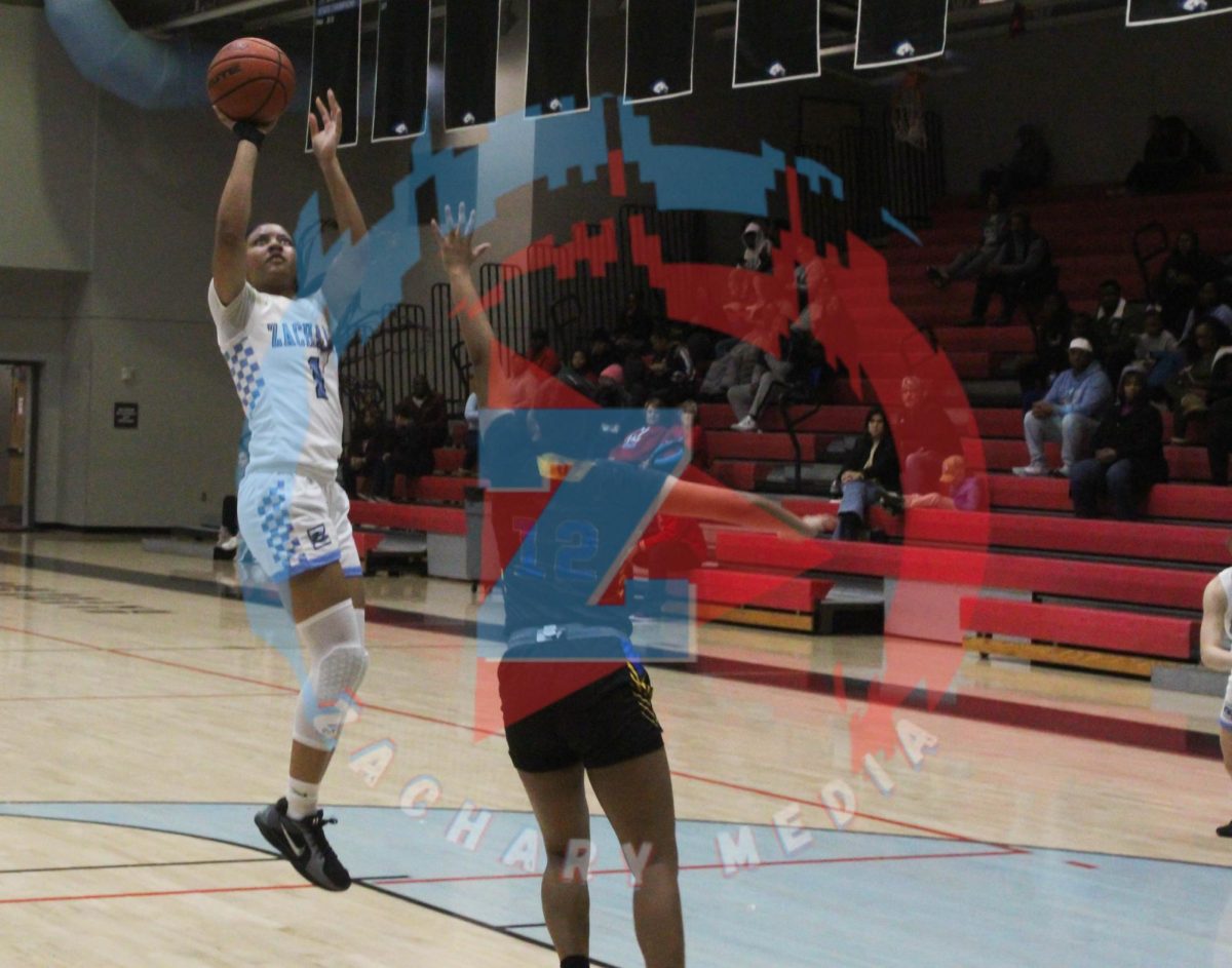 Ava Raymond (11) jumping up to throw the ball in the basket.