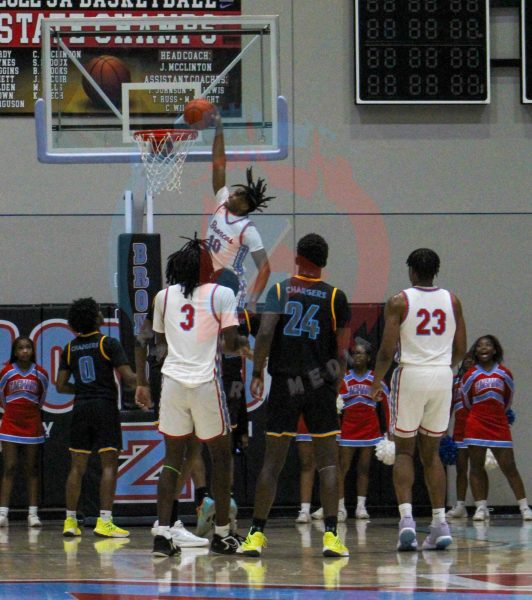 Xavier Ferguson (12) dunks the ball home following a quick change of possession. Ferguson as well as his teammates were electric following the slam dunk.