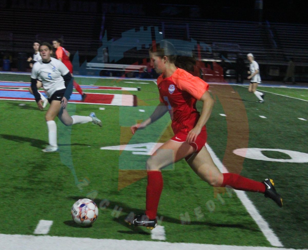 Alyssa Lillie (9) keeps the ball in her control.