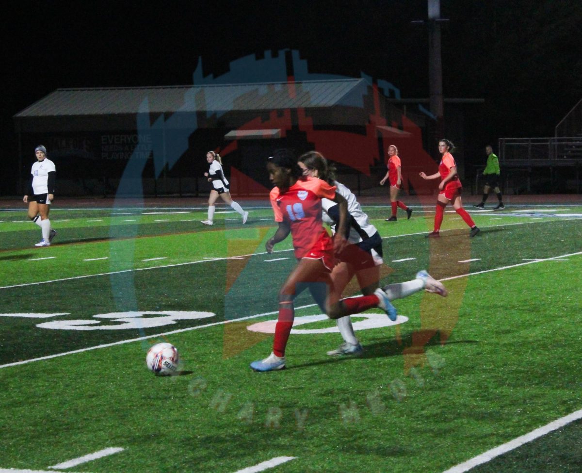 Yasmin Batchelor (12) chases after the ball, trying to get control.