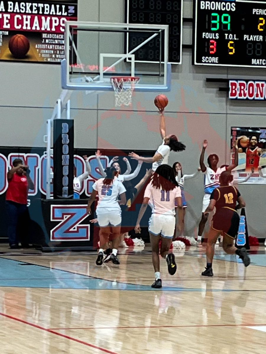 Ava Raymond (11) shooting the ball with a lay up.