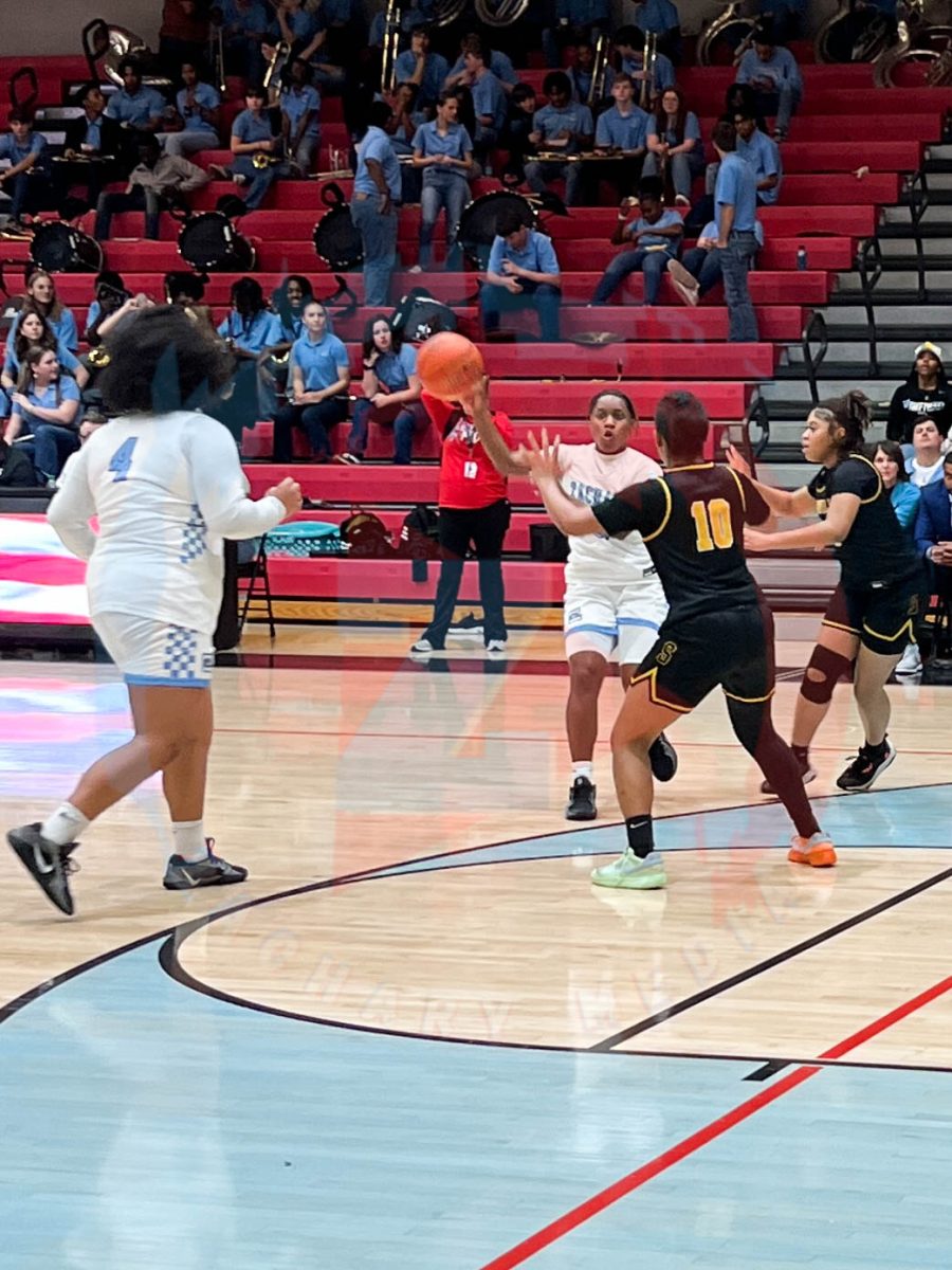 Kaitlyn Blake (12) passing the ball to Madison Alcerro (12)