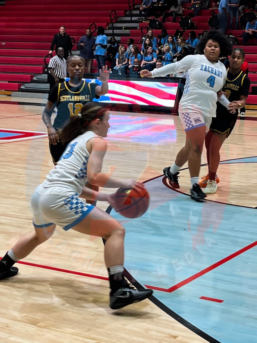 Reese Quibodeaux (12) dribbling the ball to see what to do. 