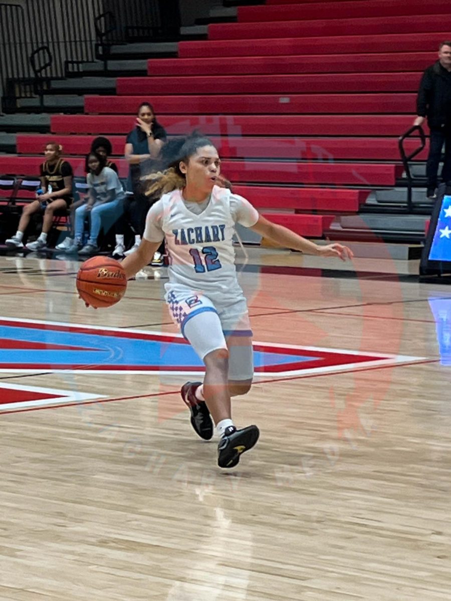 Ayja Walker (10) dribbling the ball.