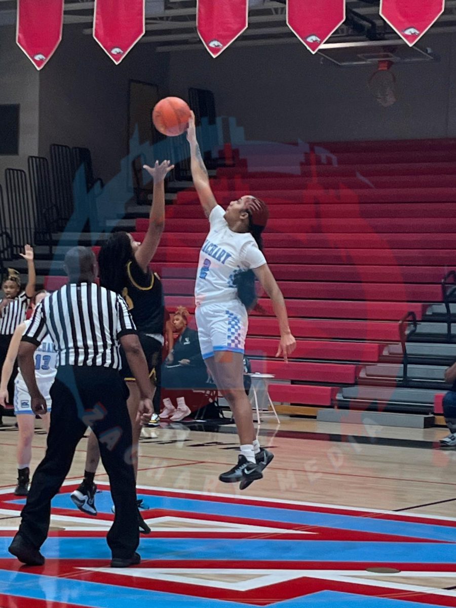 Tiarra Mcpipe (12) starting the game with a jump ball.