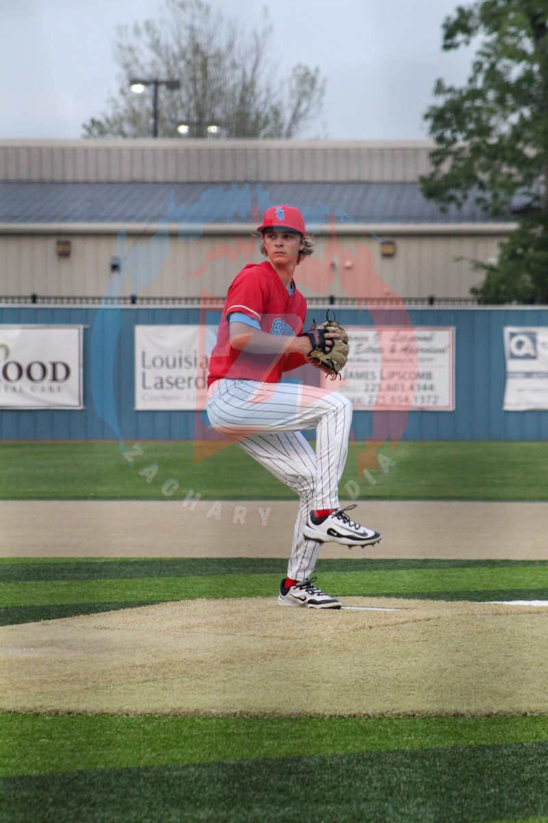 Jack Prejean (12) winds up to deliver a pitch from the mound.