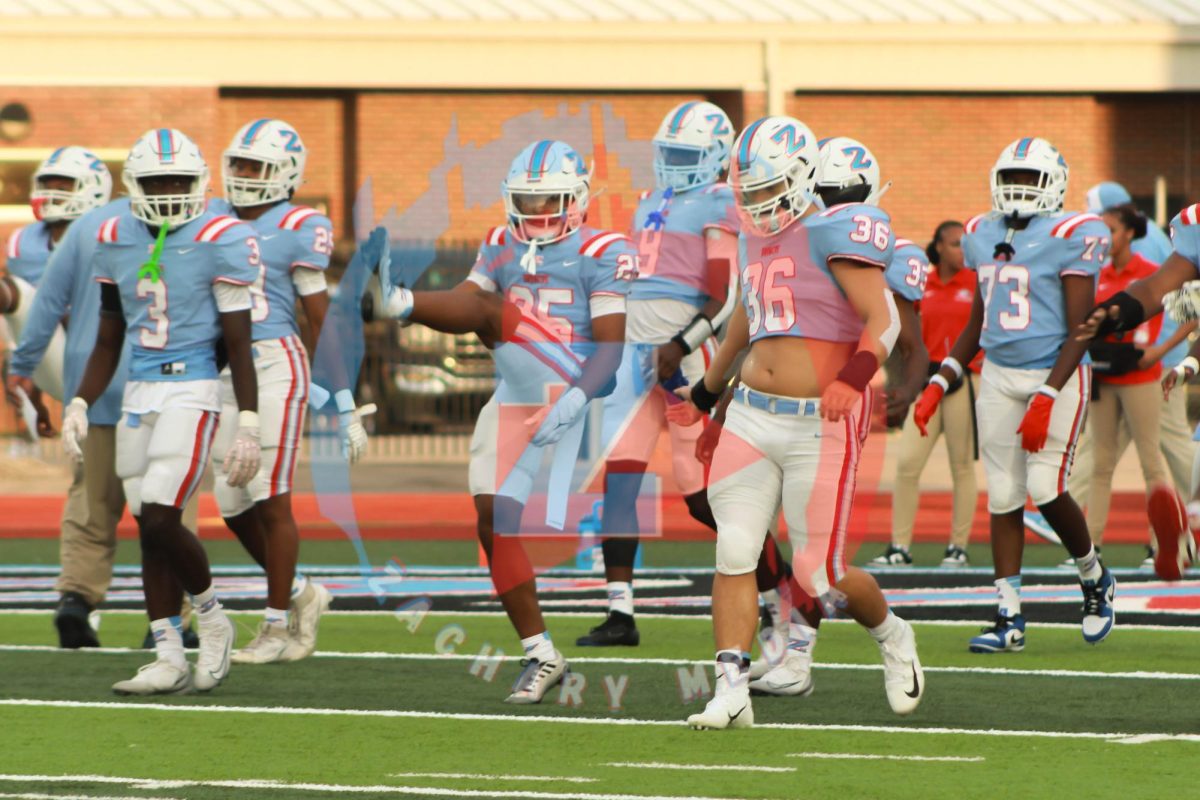 The ZHS Broncos warm up before their game against the Livonia Wildcats.
Credit: Avery Gaines.