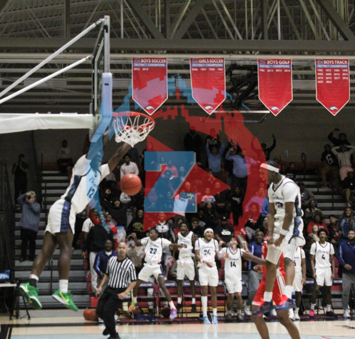 Ethan Kimmie (11) finishes a dunk as Ian Edmond (11) celebrates
